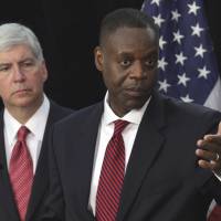 Rust belt: Detroit Emergency Manager Kevyn Orr (front) and Gov. Rick Snyder discuss the city\'s bankruptcy filing at a news conference Friday in the Motor City. | BLOOMBERG