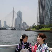 Women in yukata enjoy a boat cruise along Edogawa River. During the summer months visitors to the Eco Edo Nihonbashi event can rent yukata and enjoy the art aquarium.   | SATOKO KAWASAKI