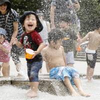 Cooling off: Children play in a park in Nerima Ward on Saturday as the mercury soared past 30 degrees in the capital. The Meteorological Agency said the same day that the rainy season in the Kanto-Koshin region including Tokyo had likely ended. | KYODO