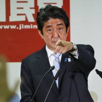 Questions and answers: Prime Minister Shinzo Abe points at a reporter during a news conference in Tokyo on Monday after his Liberal Democratic Party cruised to a comfortable victory in the House of Councilors election. Abe not in hurry to amend Constitution