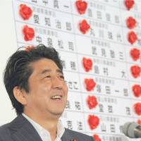 Looks tell it all: Liberal Democratic Party President Shinzo Abe smiles at LDP headquarters, while Democratic Party of Japan President Banri Kaieda frowns as they learn the results of the July 21 Upper House poll. Grip on Diet leaves no scapegoats for LDP