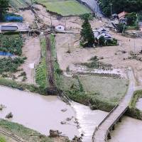 Expect delays: A Japan Railway Yamaguchi Line bridge is washed out Monday by a deluge-swollen river in the city of Yamaguchi. | KYODO