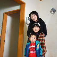 Still standing: Naoko Nakayama poses with her two children at their tsunami-damaged house in Ishinomaki, Miyagi Prefecture, before the house was reconstructed. Mom who blogged about tsunami wants people to remember