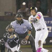 Star turn: Seiichi Uchikawa hits a tie-breaking, two-run double in the bottom of the eighth inning in the third game of the All-Star Series on Monday. | KYODO