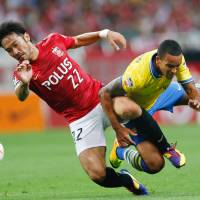 No walk in the park: Arsenal\'s Theo Walcott (right) and Urawa\'s Yuki Abe vie for the ball during Friday\'s friendly in Saitama. | AP