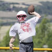Ready for action: Ashland High School quarterback Danial White practices last Friday at Phillips Field before the Grizzlies traveled across the Pacific Ocean for the 25th anniversary of the Pacific Rim Bowl\'s inception. | ASHLAND DAILY TIDINGS