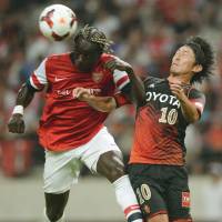 Fire at will: Arsenal\'s Bacary Sagna (left) heads the ball away from Nagoya\'s Yoshizumi Ogawa during their exhibition match at Toyota Stadium on Monday. Arsenal won 3-1. | AFP-JIJI