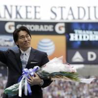 Signing off: Former Yankees slugger Hideki Matsui waves to the crowd at Yankee Stadium during his retirement ceremony on Sunday in New York. | AP
