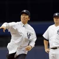 High heat: Hideki Matsui throws out the ceremonial first pitch as Yankees starter Phil Hughes watches prior to New York\'s 6-5 win over Tampa Bay on Sunday. | AP