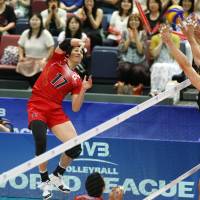 Challenging: Japan\'s Yu Koshikawa faces a trio of Canada defenders as he hits the ball during Saturday\'s match in Osaka. | FIVB