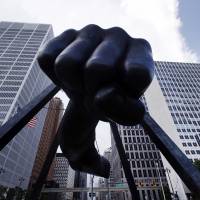 TKO: Detroit\'s skyline rises behind the Monument to Joe Louis, who was raised in the city and went on to become one of boxing\'s greatest heavyweight champions in the 1930s and 1940s. State-appointed emergency manager Kevyn Orr on Thursday asked a federal judge for permission to place Detroit into Chapter 9 bankruptcy protection. | AP