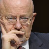 Under fire: Director of National Intelligence James Clapper listens to testimony at a Senate Intelligence Committee hearing where he testified about worldwide threats on March 12. | AP