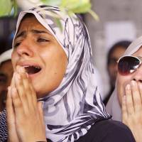 Crying out: Women grieve during a funeral service for opponents of ousted Egyptian President Mohammed Morsi on Saturday in Cairo. The opponents were killed during clashes last week. Egyptians split on choice of leader