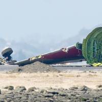 Tailing off: The detached tail and landing gear of Asiana’s Boeing 777 rest on the tarmac after the plane crashed at San Francisco International Airport on Saturday. Crisis: The final approach of Flight 214