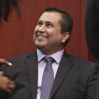 Acquitted: George Zimmerman smiles Saturday after receiving a not guilty verdict in his trial in Sanford, Florida. | AP