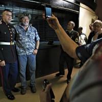 For the boys: Ted Nugent poses with members of the military backstage following an April 28 performance in Roanoke, Virginia. | THE WASHINGTON POST