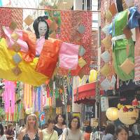 Crowds attend the opening day of the Tanabata star festival in Tokyo\'s Asagaya district on  Wednesday. Around 1 million people are expected to visit the five-day event, which is usually held in July but in Asagaya is based on the lunar calendar. | SATOKO KAWASAKI