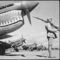 Allies: A Chinese soldier guards American P-40 planes, painted with the shark-face emblem of the \"Flying Tigers,\" in China in July 1942. | NATIONAL ARCHIVES AND RECORDS ADMINISTRATION