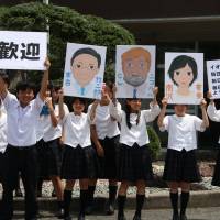 Smile council: Saya High School students welcome us on our visit there with artful portraits of (L-R) Takejiro Sueyoshi of the United Nations Environment Programme (UNEP) Finance Initiative, a fresh-faced Old Nic and actress Nao Minamisawa. | C.W. NICOL