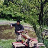 Akiyama, at work on his farm in the Fukushima Prefecture mountains in 2004. | TOYOHIRO AKIYAMA