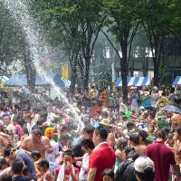 Splashing time: Visitors get wet at the Mizukake Matsuri &amp; World Festa. | MELINDA JOE