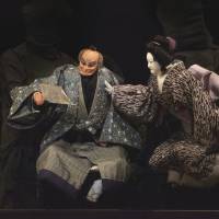 Let them eat cake: A scene from Koki Mitani\'s \"Much Ado about Love Suicides,\" in which puppets portraying manju&macr; -store owner Hanbei (center) and his wife (right) face their daughter. | FUTOSHI OSAKO