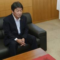 Not so fast: Industry minister Toshimitsu Motegi and consumer affairs minister Masako Mori appear Thursday before a meeting to order Hokkaido Electric Power Co., Tohoku Electirc Power Co. and Shikoku Electric Power Co. to trim their planned household rate hikes. | KYODO