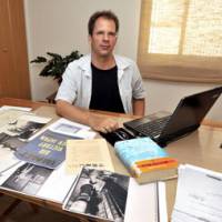 Documentation: Bret Fisk, in his office in Odawara, Kanagawa Prefecture, shows some of the materials on World War II air raids in Japan that he is compiling for a digital archive. | YOSHIAKI MIURA PHOTOS