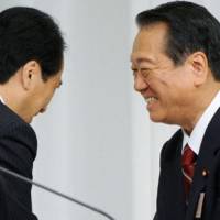 Crocodile smiles: Democratic Party of Japan kingpin Ichiro Ozawa shares smiles with Prime Minister Naoto Kan on Tuesday after losing to him in the ruling party\'s presidential election. | KYODO PHOTO