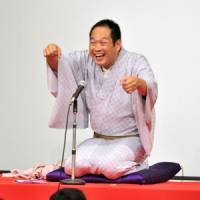 Make-believe: \"Rakugo\" storyteller Kaishi Katsura performs for readers of The Japan Times on Saturday in Tokyo, while audience members act out &#8212; with Katsura\'s guidance &#8212; how to eat noodles like a rakugo performer. | YOSHIAKI MIURA PHOTO