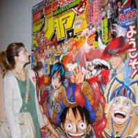 Turkish delight: A woman takes in a display at \"Discover Manga! The World of Shonen Jump,\" an exhibition that got under way Tuesday in Istanbul. | KYODO PHOTO