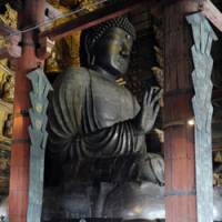 They were always there: Visitors view the Great Buddha in Nara\'s Todaiji Temple on Monday. Two swords (below) found under the statue have been identified as sacred ones unaccounted for for some 1,250 years. | KYODO PHOTO