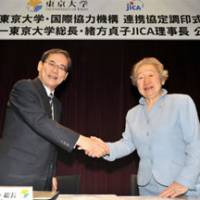 Teaming up: Sadako Ogata, president of the Japan International Cooperation Agency and former U.N. High Commissioner for Refugees, and University of Tokyo President Junichi Hamada participate in a signing ceremony at the university on Oct. 18. | YOSHIAKI MIURA PHOTO