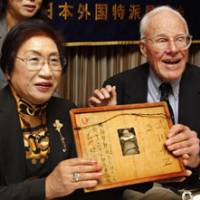 Long time coming: Franklin Hobbs, a former U.S. soldier who fought in the Battle of Iwojima, and Chie Takekawa, whose father was killed on the island, hold a framed letter and a photo of her sister at the Foreign Correspondents\' Club of Japan in Tokyo on Friday. | AP PHOTO