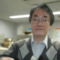No coelacanth: Kyoto University professor Tetsuji Nakabo displays a \"kunimasu,\" or black kokanee, salmon at his office in Kyoto on Wednesday. | KYODO PHOTO