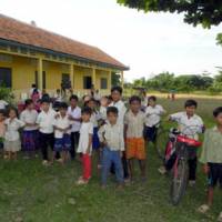 Building lives: Kids stand in front of Damrei Krom Primary School, built by AMATAK in Banteaymeanchey Province, Cambodia, in this Aug. 26 photo. | COURTESY OF AMATAK HOUSE OF CAMBODIA