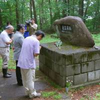 Starting off right: Officials pray in front of a monument commemorating those who died in the \"special prison\" that existed in Kuriu Rakusenen loprosarium in Kusatsu, Gunma Prefecture, before beginning on Tuesday a research excavation. | KYODO