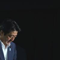 Make or break decision: Prime Minister Shinzo Abe leaves after speaking to the media at his party headquarters in Tokyo on July 21. He will decide whether to raise the consumption tax after analyzing economic growth data. | BLOOMBERG