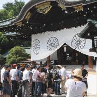 Solemn: People pray for the war dead Thursday at Tokyo\'s Yasukuni Shrine. | SATOKO KAWASAKI