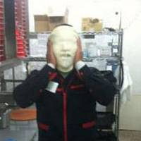 Hand-tossed: A Twitter image shows a part-time worker at a Pizza Hut plastering pizza dough all over his face in May. | KYODO