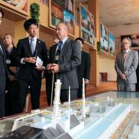 Reality check: Foreign Minister Fumio Kishida (left) is briefed on the status of the Chernobyl nuclear power plant during his visit to Ukraine on Sunday. | KYODO