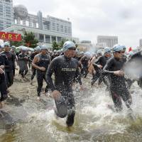 Big splash: Participants taking part in a swimming and running race Saturday to promote Tokyo\'s bid to host the 2020 Summer Games set out from the starting line in Odaiba. | KYODO