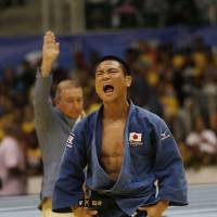 Clean sweep: Masashi Ebinuma celebrates after beating Azamat Mukanov in the men\'s 66-kg final on Tuesday. | AP