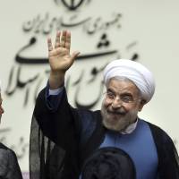 Shift in direction?: New Iranian President Hasan Rouhani waves after his swearing in ceremony in Tehran on Sunday. | AP