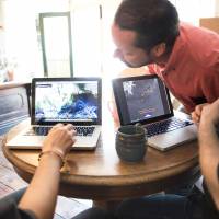 Post-modern environmental movement: SkyTruth members (from left) David Manthos, John Amos and Paul Woods huddle around their computers during a meeting at Mellow Moods Cafe in Shepherdstown, West Virginia, in April. | THE WASHINGTON POST