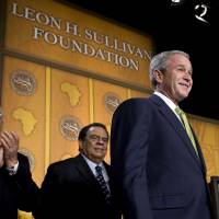 Top-tier: Howard Jeter (left), president and chief executive officer of the Leon H. Sullivan Foundation, and Andrew Young, former mayor of Atlanta, welcome U.S. President George W. Bush to a meeting of the foundation in Washington on Feb. 26, 2008. Former President Bill Clinton was also among the supporters and guests at the foundation’s lavish events and parties. Leon H. Sullivan Foundation: the implosion of a legacy