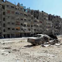Shattered lives: Heavily damaged buildings stand in Zamalka, a suburb of Damascus, in this image released by the Syrian opposition\'s Shaam News Network on Aug. 17. | AFP-JIJI