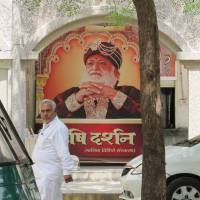 Guilty guru?: An image of Asaram Bapu, arrested last month on charges of sexually assaulting a 16-year-old girl, adorns the walls of his ashram in Motera, India, on Sept. 8. Wealthy guru's arrest on teen sex assault charges divides India