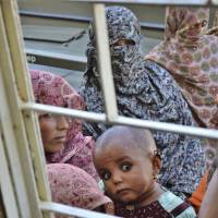Waiting room: Pakistani women gather to receive medical relief at a clinic on  Thursday in Labach, a remote district in Baluchistan province, after  Tuesday\'s magnitude 7.7 earthquake. | AP