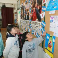 Students at a Japanese school in Buenos Aires look at a bulletin board  Tuesday full of material on  Tokyo\'s bid to host the 2020 Olympics. The International Olympic Committee will meet in Buenos Aires this weekend to choose the host city. | KYODO